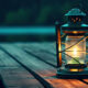 Lit lantern at night on a wooden dock
