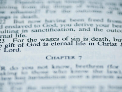 Bible open to Romans 6:23